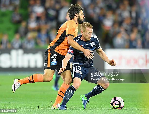 Oliver Bozanic of the Victory is challenged by Thomas Broich of the Roar during the round 15 A-League match between the Melbourne Victory and the...