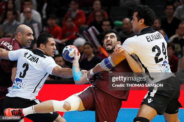 Egypt's pivot Ibrahim El-Masry holds back Qatar's centre back Kamal Mallash during the 25th IHF Men's World Championship 2017 Group D handball match...