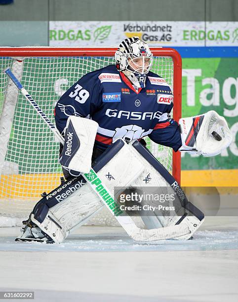 Marvin Cuepper of the Eisbaeren Berlin jumps to save goal the puck during the action shot on August 27, 2016 in Dresden, Germany.