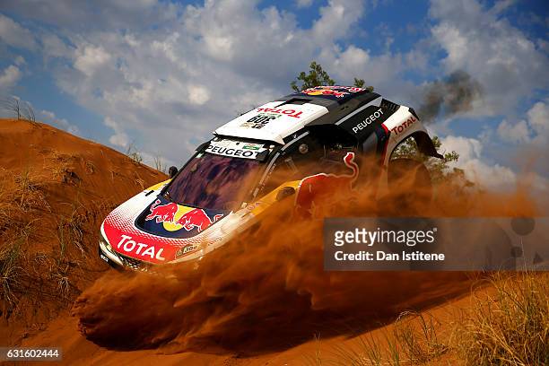 Sebastien Loeb of France and Peugeot Total drives with co-driver Daniel Elena of Monaco in the 3008 DKR Peugeot car in the Classe : T1.4 2 Roues...