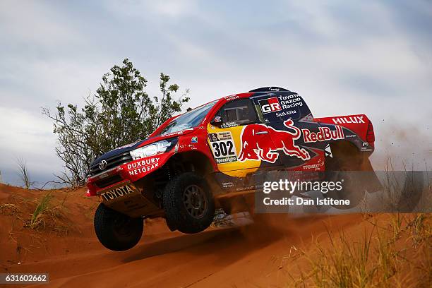 Giniel De Villiers of South Africa and Toyota Gazoo Racing drives with co-driver Dirk Von Zitzewitz of Germany in the Hilux Toyota car in the Classe...