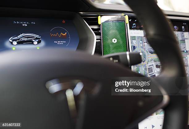 An Uber Technologies Inc. App sits on a smartphone inside a Tesla Motors Inc. Model S electric automobile in Madrid, Spain, on Friday, Jan. 13, 2017....