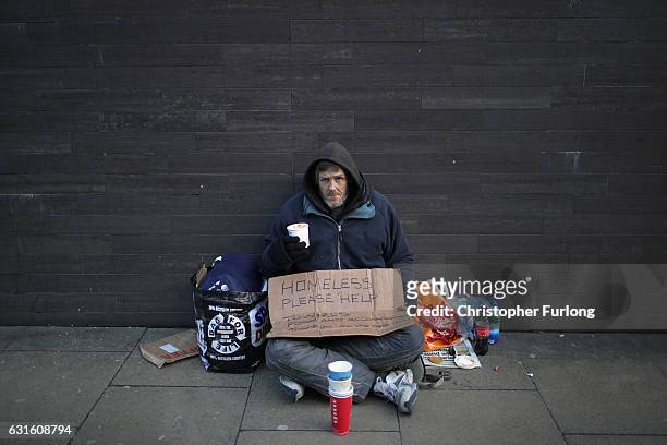 Homeless man begs for small change on the streets of Manchester on January 13, 2017 in Manchester, United Kingdom. Many homeless people are spending...