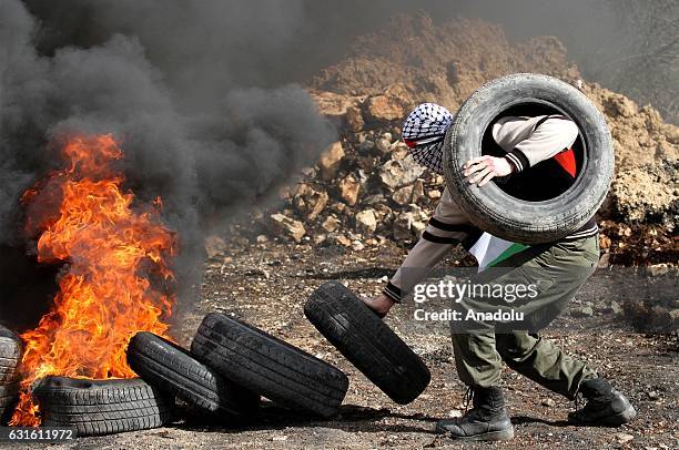 Palestinian protester burns tyres during a protest against land expropriations by Israeli Government, at Kafr Kaddum village of Nablus, West Bank on...