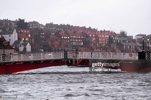 Water levels rise up close to the swing bridge as a tidal surge causes flooding on January 13, 2017 in Whitby, United Kingdom. Strong northerly winds...