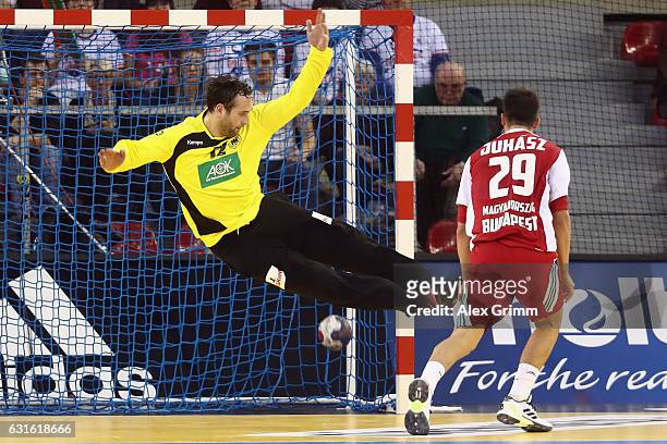 Adam Juhasz of Hungary scores a goal against goalkeeper Silvio Heinevetter of Germany during the 25th IHF Men's World Championship 2017 match between...