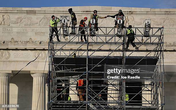 Workers prepare the stage in front of the Lincoln Memorial to be used in the presidential inauguration festivities for President elect Donald Trump...