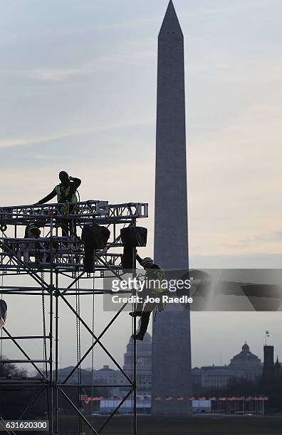 Workers prepare the stage near the Washington Monument and in front of the Lincoln Memorial to be used in the presidential inauguration festivities...