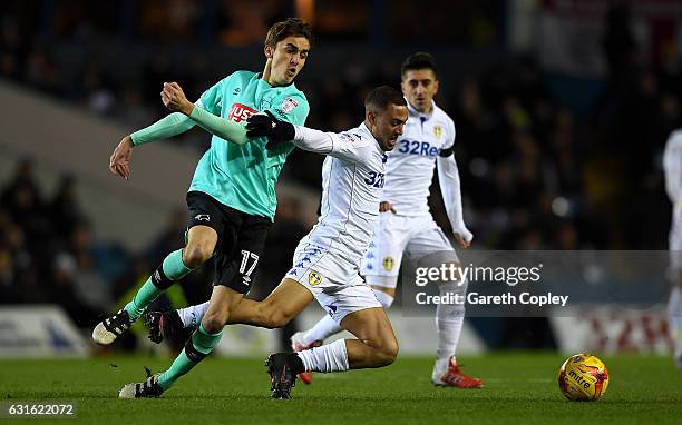 Kemar Roofe of Leeds is tackled by Julien De Sart of Derby during the Sky Bet Championship match between Leeds United and Derby County at Elland Road...