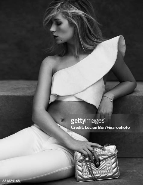 Model Lottie Moss poses at a fashion shoot for Madame Figaro on November 29, 2016 in Paris, France. Top , jeans , Serpenti Forever bag, Divas Dream...