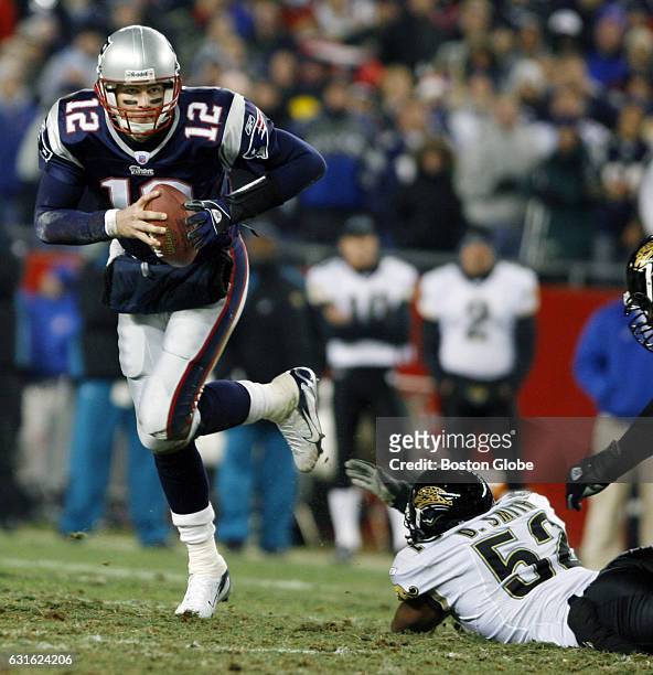 Patriots quarterback Tom Brady eludes the rush of the Jaguars' Daryl Smith as he rolls out and looks to pass. The New England Patriots face the...