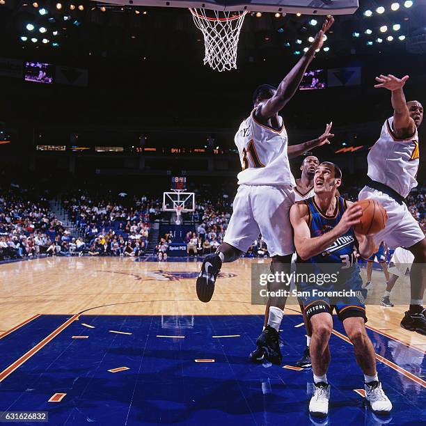 Scot Pollard of the Detroit Pistons shoots against the Golden State Warriors on November 12, 1997 at Oracle Arena in Oakland, California. NOTE TO...