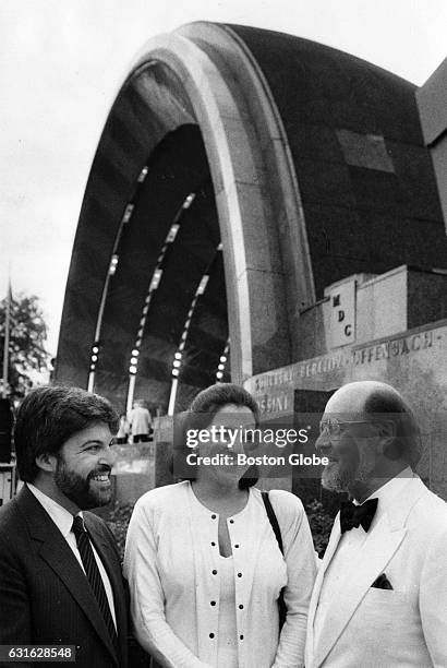 Arthur Fiedler's children Peter and Johanna chat with John Williams Pops conductor by the Hatch Shell on the Charles River Esplanade in Boston, July...