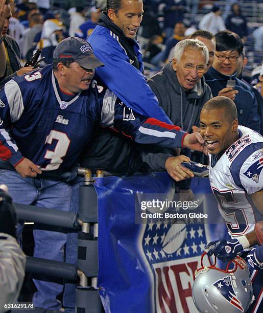 Patriots defensive back Artrell Hawkins celebrates with some New England fans in the stands following the victory over the Chargers. The New England...