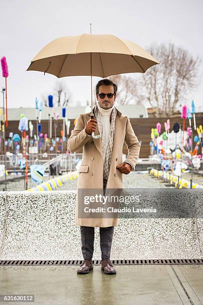 Andrea Raffaelli, with sartorial coat, Re-hash trousers, Pasotti umbrella, Fratelli Rossetti shoes and Gran Sasso sweater, is seen on January 13,...