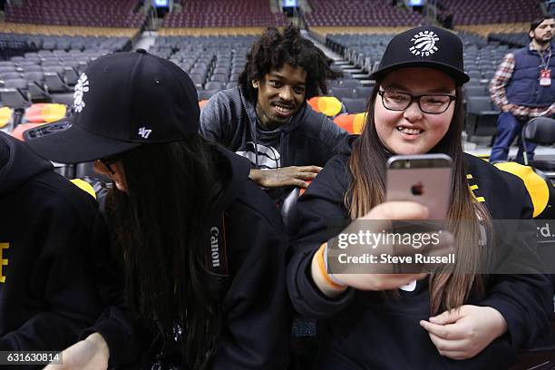 Toronto Raptors center Lucas Nogueira poses with Allay Moise, part of a group of children from La Loche. Toronto Raptors general manager Masai Ujiri...