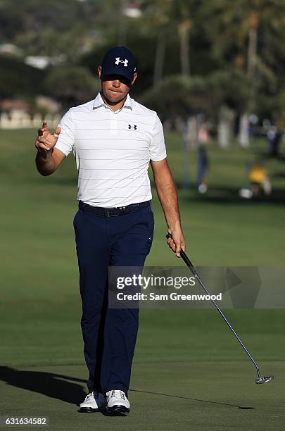 Gary Woodland of the United States reacts after putting for birdie on the 18th green during the second round of the Sony Open In Hawaii at Waialae...