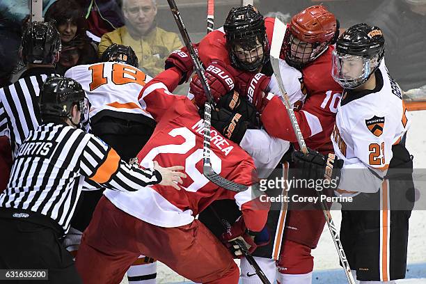 Joe Grabowski of the Princeton Tigers keeps Alec McCrea of the Cornell Big Red in a front headlock as Beau Starrett of the Cornell Big Red tries to...
