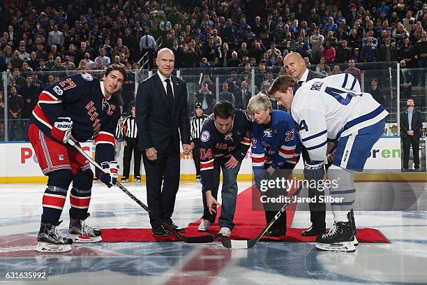 Wife Patti Ann and Son Conor of the late Det. Steven McDonald drop the ceremonial puck prior to the game between the New York Rangers and the Toronto...