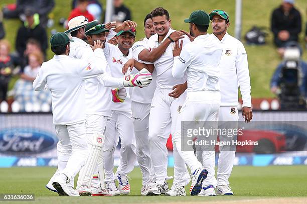 Taskin Ahmed of Bangladesh celebrates with teammates after taking the wicket of Kane Williamson of New Zealand during day three of the First Test...