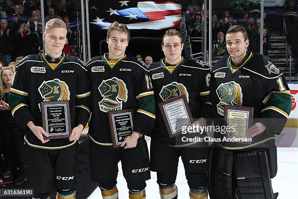World Junior participants Olli Juolevi, Janne Koukkanen, Mitchell Stephens, and Tyler Parsons of the London Knights are honoured prior to play...