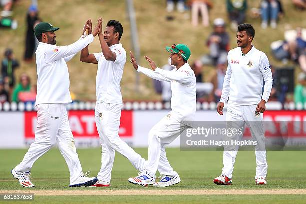 Kamrul Islam Rabbi of Bangladesh is congratulated by teammates after taking the wicket of Ross Taylor of New Zealand during day three of the First...