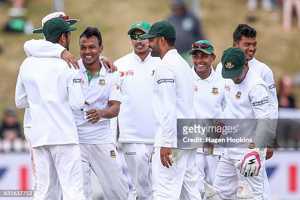 Kamrul Islam Rabbi of Bangladesh celebrates with teammates after taking the wicket of Ross Taylor of New Zealand during day three of the First Test...
