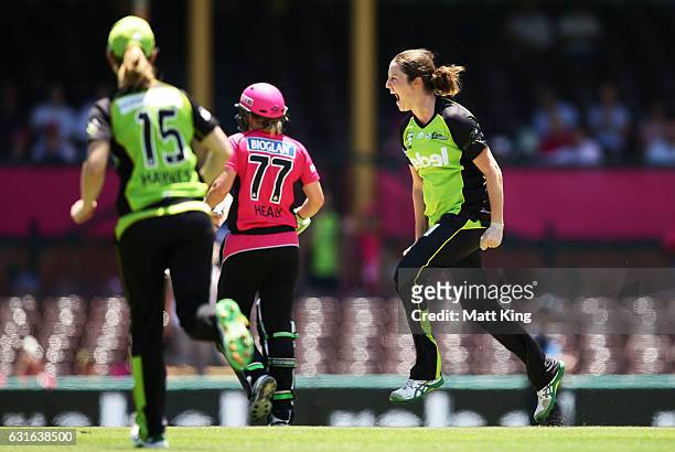 Rene Farrell of the Thunder celebrates taking the wicket of Alyssa Healy of the Sixers during the Women's Big Bash League match between the Sydney...