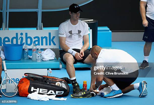 Andy Murray of Great Britain has treatment on his left foot from his physio Shane Annun during a practice session ahead of the 2017 Australian Open...