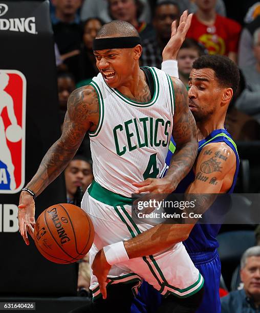 Isaiah Thomas of the Boston Celtics loses the ball as he drives into Thabo Sefolosha of the Atlanta Hawks at Philips Arena on January 13, 2017 in...