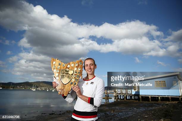 Elise Mertens of Belgium poses with the winners trophy at Cornelian Bay after victory in her singles final match against Monica Niculescu of Romania...
