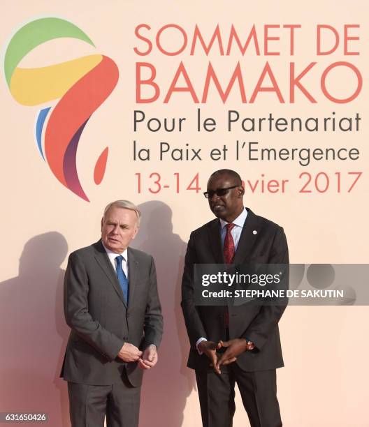 French Minister of Foreign Affairs Jean-Marc Ayrault speaks with Malian Foreign Affairs Minister Abdoulaye Diop upon his arrival for the start of the...
