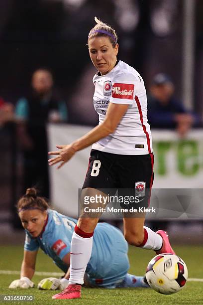 Erica Halloway of Western Sydney beats United goalkeeper Sarah Willacy to get in and score a goal during the round 12 W-League match between Adelaide...