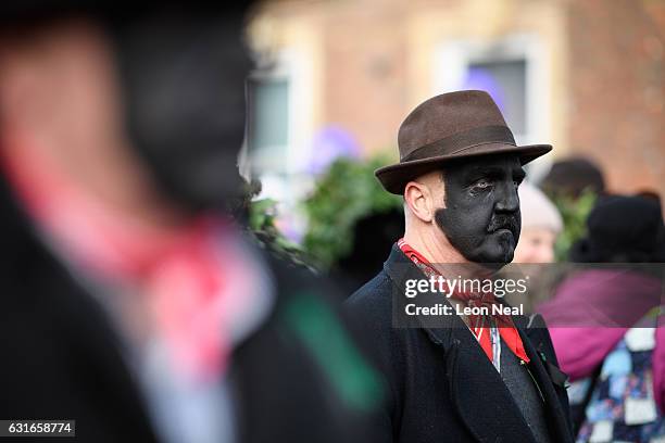 Dancers in the traditonal costume watch proceedings following the annual Whittlesea Straw Bear Festival parade on January 14, 2017 in Whittlesey,...