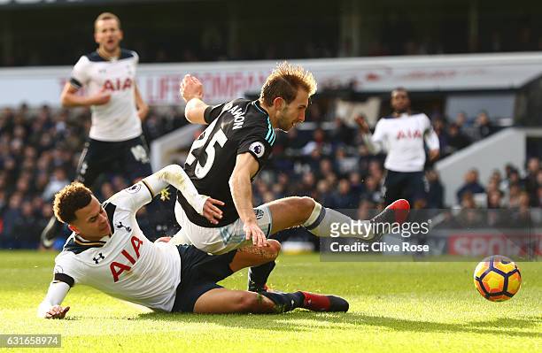Dele Alli of Tottenham Hotspur and Craig Dawson of West Bromwich Albion battle for possession during the Premier League match between Tottenham...