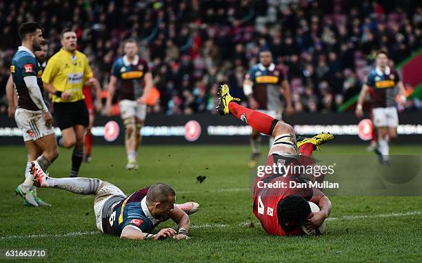 Fraser McKenzie of Edinburgh dives over to score his side's first try under pressure from Mike Brown of Harlequins during the European Rugby...