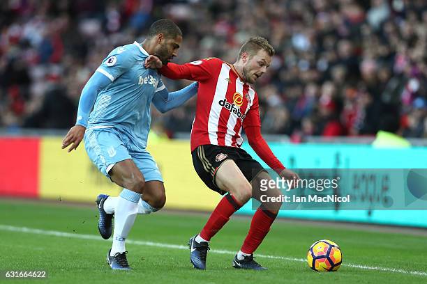 Glen Johnson of Stoke City puts pressure on Sebastian Larsson of Sunderland during the Premier League match between Sunderland and Stoke City at...