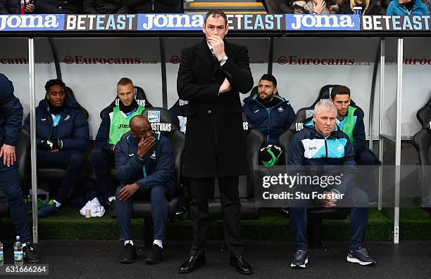 Paul Clement manager of Swansea City looks on from the bench alongside new assistant Claude Makelele prior to the Premier League match between...