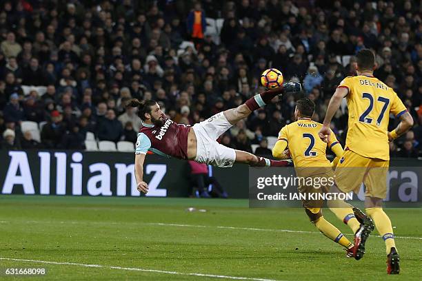 West Ham United's English striker Andy Carroll shoots to score their second goal with this bicycle kick during the English Premier League football...