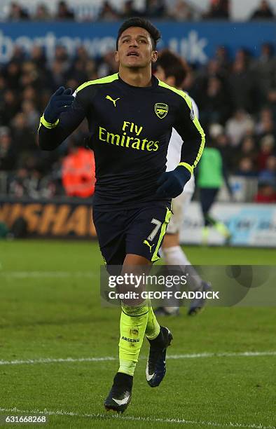 Arsenal's Chilean striker Alexis Sanchez celebrates scoring his team's fourth goal during the English Premier League football match between Swansea...