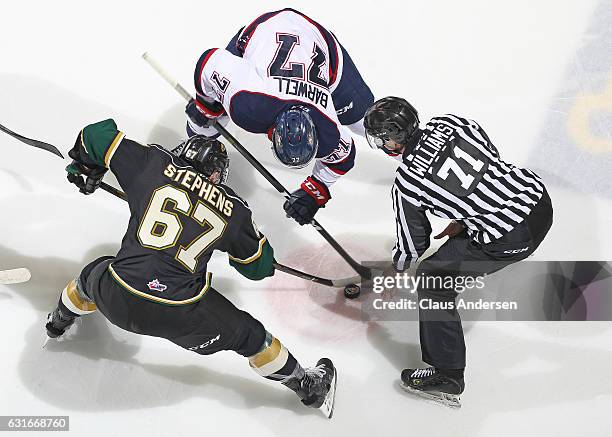 Mitchell Stephens of the London Knights takes a faceoff against Jesse Barwell of the Saginaw Spirit during an OHL game at Budweiser Gardens on...