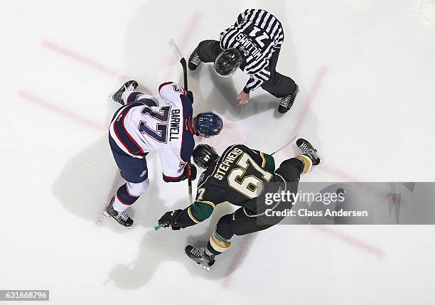 Mitchell Stephens of the London Knights takes a faceoff against Jesse Barwell of the Saginaw Spirit during an OHL game at Budweiser Gardens on...