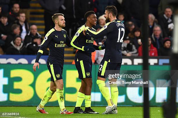Aaron Ramsey of Arsenal , Alex Iwobi of Arsenal and Olivier Giroud of Arsenal celebrate their second goal as Jack Cork of Swansea City scores a own...