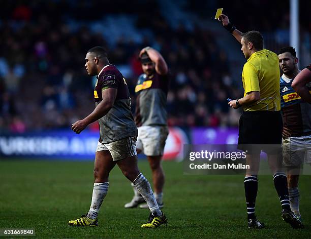 Referee, David Wilkinson shows Kyle Sinckler of Harlequins a yellow card for an off the ball tackle on Magnus Bradbury of Edinburgh during the...