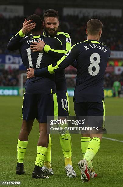 Arsenal's Nigerian striker Alex Iwobi celebrates his team's second goal with Arsenal's French striker Olivier Giroud , after his shot was defelected...