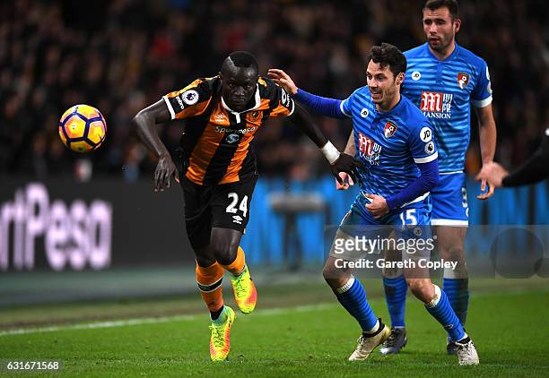 Oumar Niasse of Hull City and Adam Smith of AFC Bournemouth battle for possession during the Premier League match between Hull City and AFC...