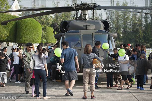 Children with parents in queue for visit inside a military helicopter during the National Children's Day event inside a military base in Bangkok,...