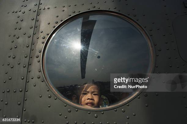 Thai boy looks out from a military helicopter during the National Children's Day event inside a military base in Bangkok, Thailand, on 14 January...