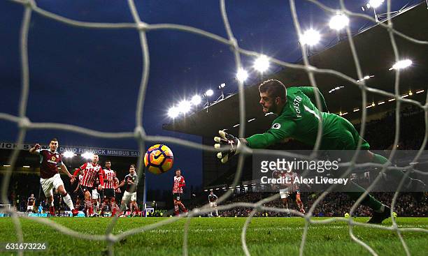 Joey Barton of Burnley scores his sides first goal past Fraser Forster of Southampton during the Premier League match between Burnley and Southampton...