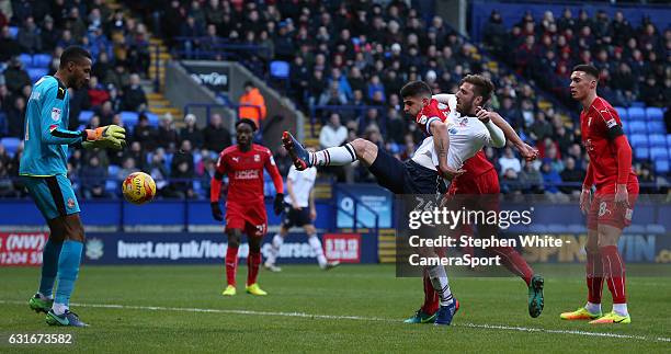 Bolton Wanderers' James Henry appears to be impeded by Swindon Town's Lloyd Jones as he attempts a shot at goal during the Sky Bet League One match...